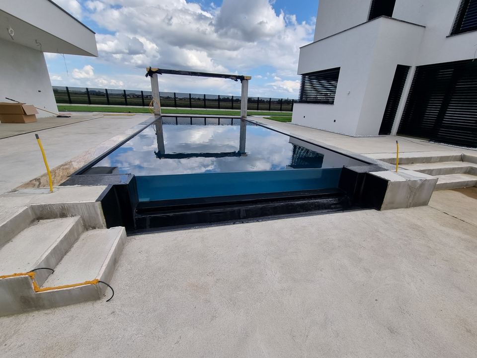 Pool mit Stufen, Randsteinen und Belag aus hellem Stein