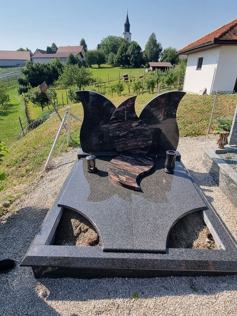 Doppelgrabstein aus schwarzem Granit in Form eines Schmetterlings